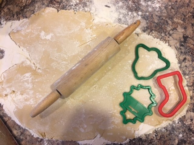 making christmas roll out cookies with rolling pin